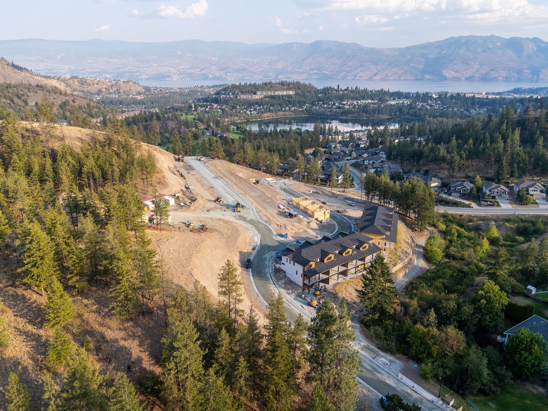Paramount Peak townhomes under construction from the air, with Shannon Lake, the golf course and Okanagan Lake beyond