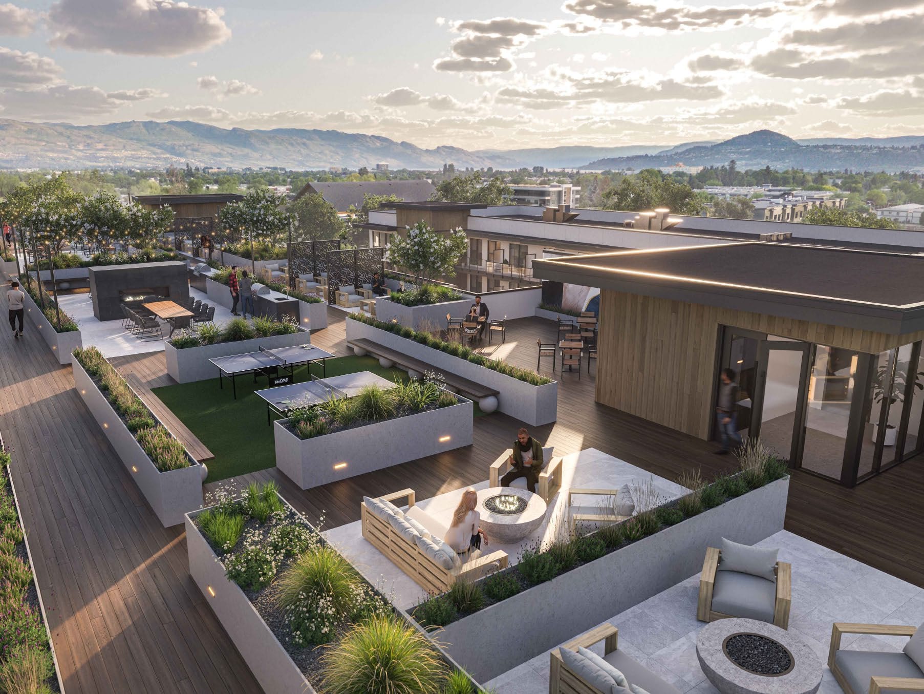 Rendering of the Revo rooftop terrace at dusk, lounges and fire tables with the mountains behind. Artist's rendering